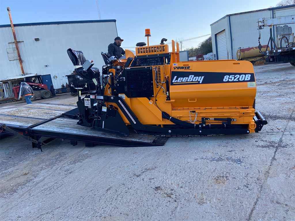 BG Paving Worker Operating LeeBoy Machine